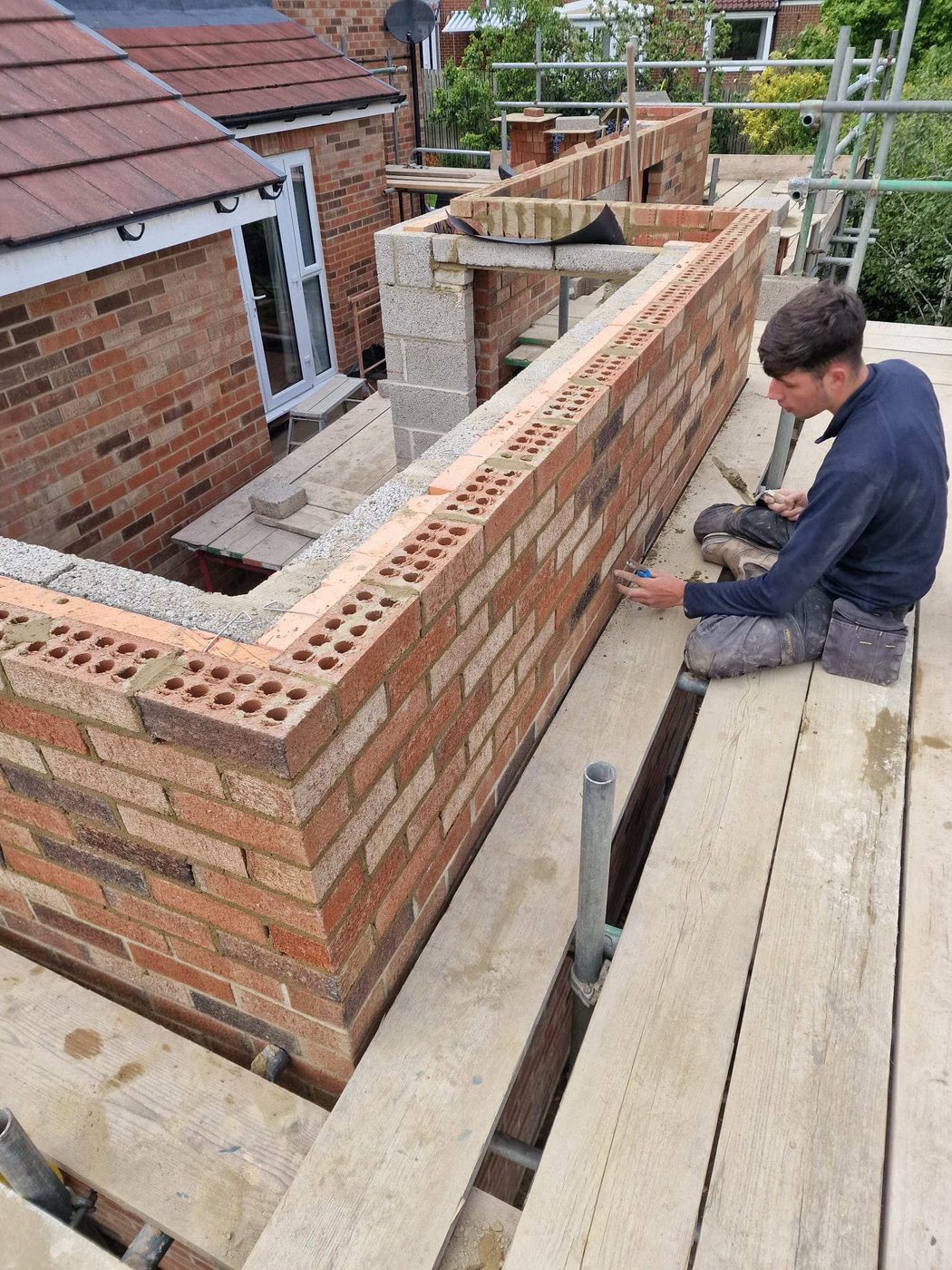 Neil's team laying brickwork on an extension